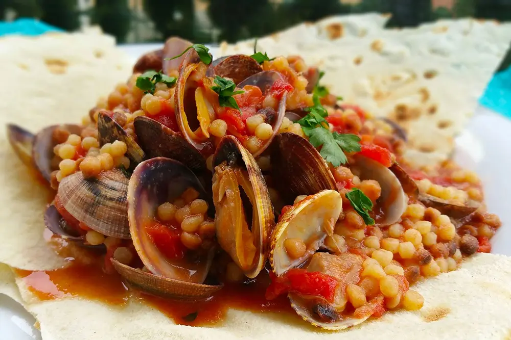 Fregola, pictured here with clams, is a typical Sardinian pasta similar to cous cous buonissimo food fregola with claims sardegna italy issimo