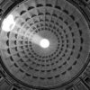 The sun illuminates the inside of the ceiling through the hole at the top of the Pantheon in Rome, Italy