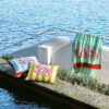ISSIMO X Lisa Corti bougainvillea stripes baby pillow, sea lifestyle view mustard home decor